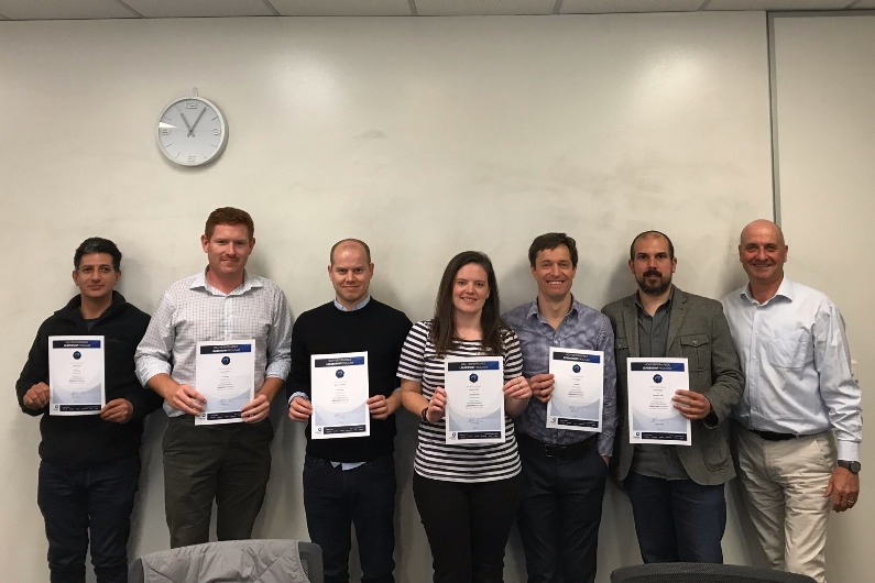 A group of people holding their certificates